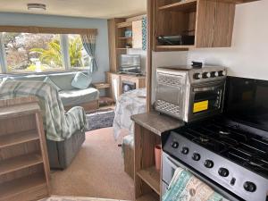 a kitchen and living room of a caravan at Spacious Holiday Home in Exmouth Ocean Views and Pet Friendly in Exmouth