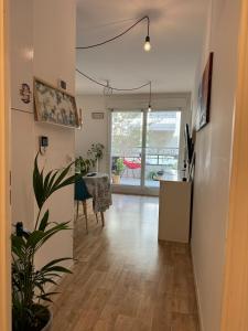 a hallway with a living room and a dining room at Appartement T2 à Chelles - Paris, CDG & Disneyland à proximité, parking privé in Chelles