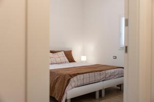 a bedroom with a bed in a white room at Serraglia Guest House in San Trovaso +38 photos