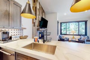 a kitchen with a sink and a counter top at Ski and Ski Out Designer Condo With a View in Kingswood Estates