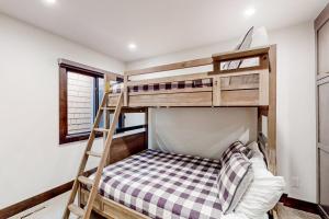 a bunk bed with a ladder in a room at Ski and Ski Out Designer Condo With a View in Kingswood Estates +28 photos