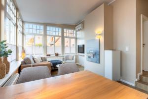 a large living room with a table and chairs at Woge2 Appartement 1 in Borkum
