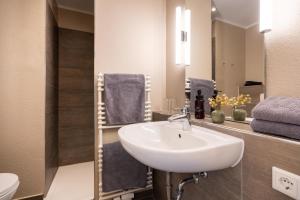 a bathroom with a sink and a mirror at Woge2 Appartement 1 in Borkum