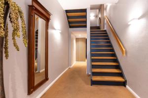 a hallway with a staircase and a mirror at Woge2 Appartement 1 in Borkum +4 photos
