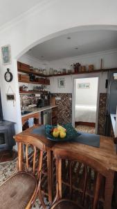 a kitchen with a table with a bowl of fruit on it at La Casita in Torrox