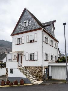 a large white house with a staircase in front of it at Frankfurter Haus in Zell an der Mosel
