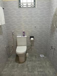 a bathroom with a toilet and a shower stall at Westwood Homes in Kilifi +31 photos