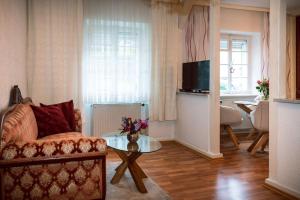 a living room with a couch and a table at Frankfurter Haus in Zell an der Mosel