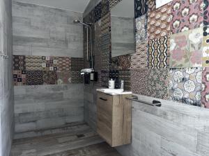 a bathroom with a shower and a sink and tiles at Finca Avellaneda in Navahonda +40 photos