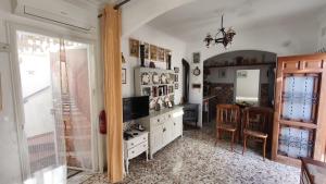 a living room with a television and a table with chairs at La Casita in Torrox