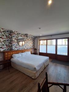 a bedroom with a large bed and a mirror at Manoir Du Cunningham in Saint Malo