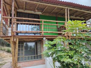 a wooden building with a balcony on top of it at Salon de eventos cabaña el Chalet in Paipa