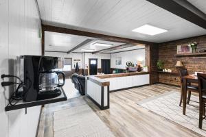 a kitchen and living room with a counter and a microwave at Hoofbeat Haven in Sturgis