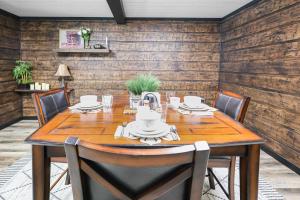 a dining room with a wooden table and chairs at Hoofbeat Haven in Sturgis +45 photos