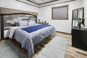 a bedroom with a large bed and a television at Hoofbeat Haven in Sturgis
