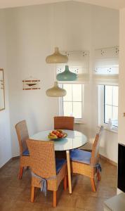 a dining room table with chairs and a plate of fruit on it at Casa Panorama in La Pared