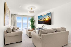 a living room with two couches and a view of the ocean at Buena Vida 22 - A in Navarre