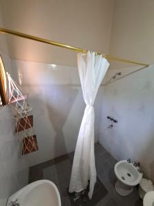 a bathroom with a white shower curtain and a sink at Casa en El Rodeo in El Rodeo +16 photos
