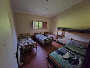 a room with three bunk beds and a window at Casa en El Rodeo in El Rodeo