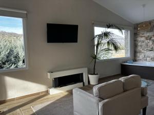 a living room with a couch and a tv at Finca Avellaneda in Navahonda