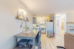 a kitchen and dining room with a table and a refrigerator at Tranquil condo in Stateline sleeps 4 in Stateline