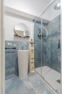a bathroom with a shower with a sink and a mirror at L'Acqua e la Pietra in Rapolano Terme +88 photos