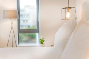 Postel nebo postele na pokoji v ubytování NLH FIX | Neighborhood Lifestyle Hotels