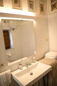 a bathroom with a sink and a mirror at Alberto Charming Home in Montepulciano +41 photos