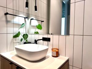 a bathroom with a bowl sink and a mirror at Stylish Industrial City Retreat in Bowden +11 photos
