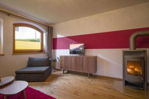 a living room with a couch and a fireplace at Ferienwohnung Hauser in Söll