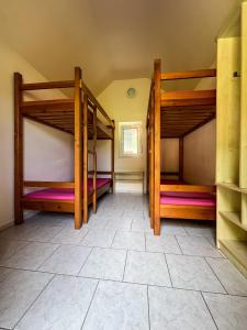 two bunk beds in a room with a tile floor at Kemp Koruna in Zlatá Koruna