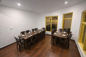 a conference room with tables and chairs in it at THE NUN KUN Pahalgam in Pahalgām
