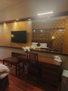 a hotel room with a table and a mirror at Faran Hotel in Karachi +28 photos