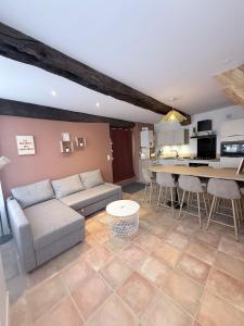 a living room with a couch and a table at Le Cocon - Vue sur le Port de DINAN - Parking privé in Lanvallay
