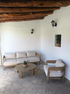 a living room with a couch and a table at Can Joan Yern in Sant Joan de Labritja