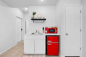 a kitchen with a red refrigerator and a sink at The Container Retreat - 4A. in Canyon Lake