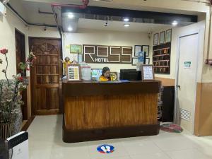 a woman sitting at a counter in a coffee shop at RTRoss Hotel in Masbate