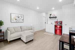 a living room with a couch and a red refrigerator at The Container Retreat - 4A. in Canyon Lake +13 photos