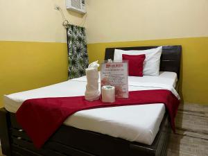 a hotel room with two beds with red pillows at RTRoss Hotel in Masbate +3 photos