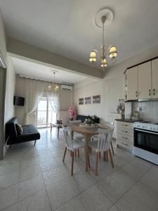 a kitchen and living room with a table and chairs at Vintage Home in Ouranoupoli