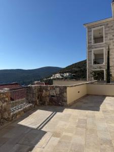 a house with a stone wall and a building at Iris in Radovici