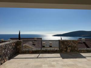 a view of the ocean from a stone wall at Iris in Radovici
