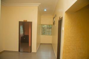 an empty hallway with a door and a window at Classic Hills Hotel & Resort in Uyo