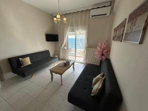 a living room with a couch and a table at Vintage Home in Ouranoupoli