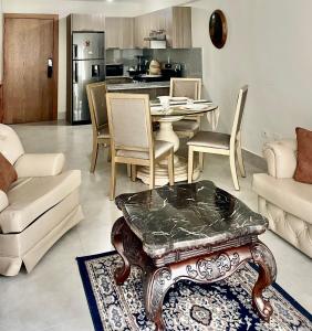 a living room with a table and a kitchen at Vista Marina Boca Chica in Boca Chica +26 photos