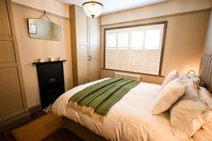 a bedroom with a large bed with a window at Hythe House in Hythe