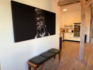 a large painting of a man on the wall in a kitchen at Speicherstübchen im alten Speicher in Schönberg +12 photos