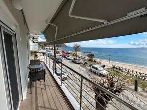 a balcony of a house with a view of the beach at Vintage Home in Ouranoupoli