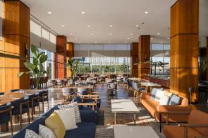 a restaurant with blue couches and tables and windows at Crowne Plaza Istanbul West-Beylikduzu By IHG in Istanbul