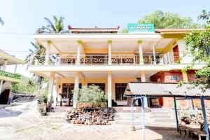 a building with a pile of fire wood in front of it at Penginapan Barokah in Kemadang